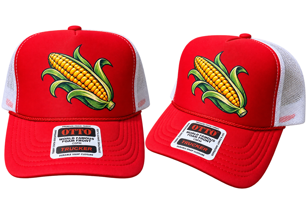 Two red trucker hats with white mesh back panels, featuring a large embroidered corn graphic on the front and a white rectangular brim patch that reads 'OTTO WORLD FAMOUS FORGED TRUCKER'.