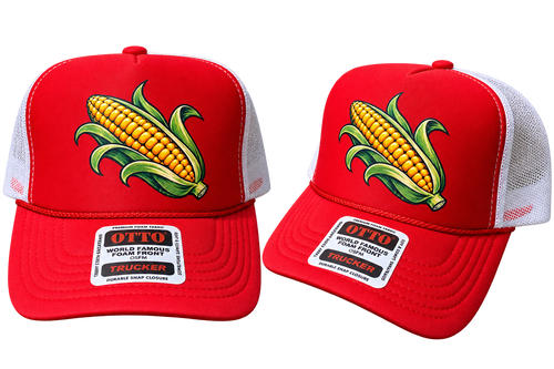 Two red trucker hats with white mesh back panels, featuring a large embroidered corn graphic on the front and a white rectangular brim patch that reads 'OTTO WORLD FAMOUS FORGED TRUCKER'.